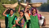 Bangladeshi women repair a rural road.