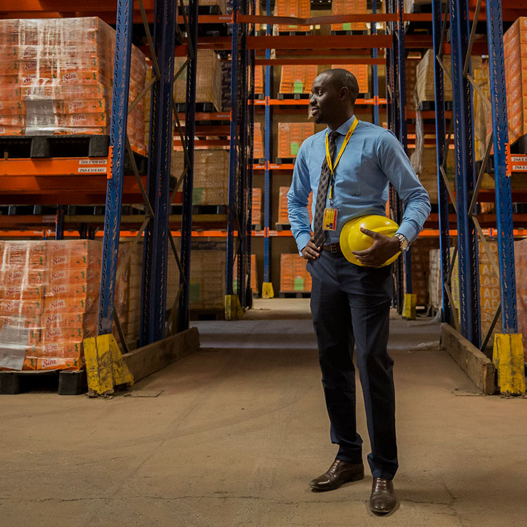 A man in Senegal stands in a warehouse in Senegal