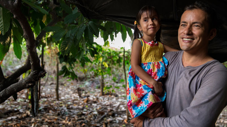 Yamid Duran Ramirez holds his daughter Leyla Duran Vergora after working on his farm where he grows passion fruit, in the township of La Paz, Colombia on January 12, 2015. Photo © Dominic Chavez/World Bank