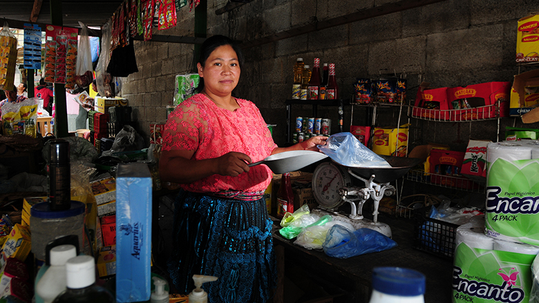 A woman attends her post in a market in Guatemala City. Guatemala. Photo: Maria Fleischmann / World Bank