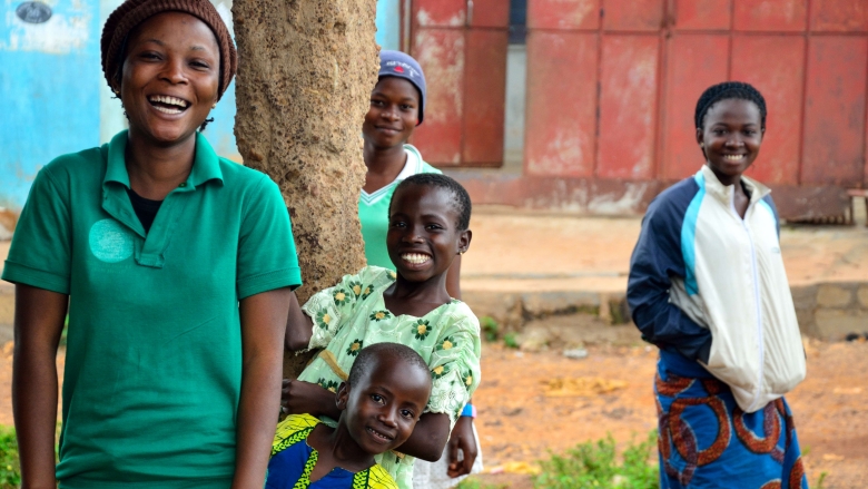 Study participants with their younger siblings outside the community screenings. © Dante Donati