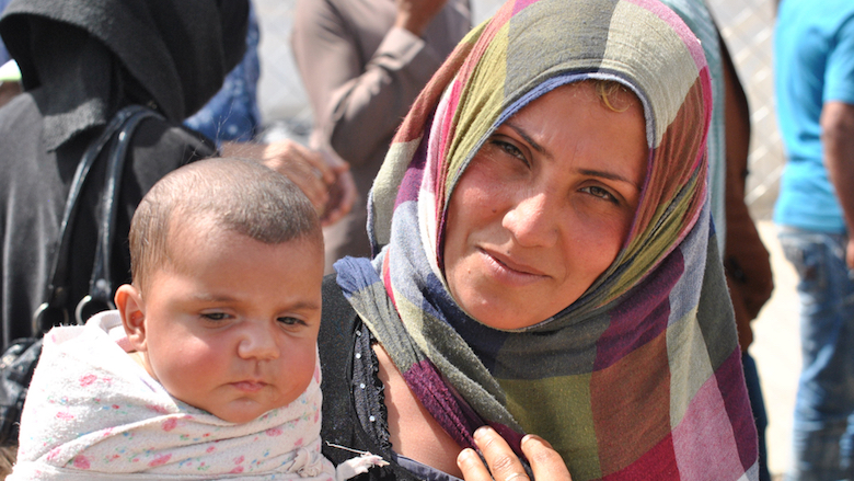 A refugee from Mosul showing her baby in refugee camp in Kurdistan, Iraq. Photo: Lena Ha / Shutterstock