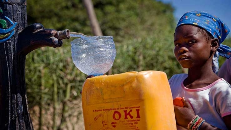 African girl picking water