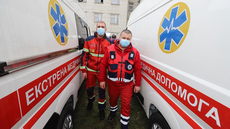 Medical staff standing between two ambulances in Lviv, Ukraine