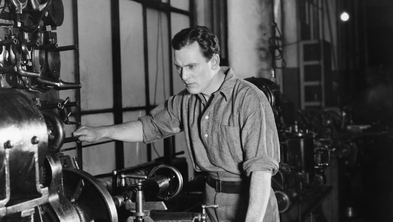 Factory worker running a machine