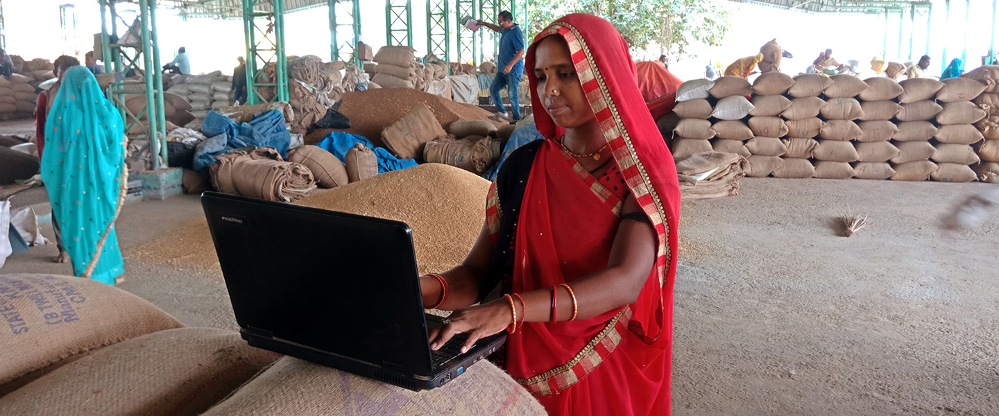 Indian village woman farmer working on laptop computer at agricultural center