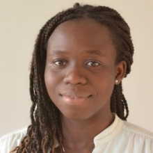 woman smiling and wearing white blouse