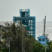 Early stage building construction and heavy equipment on a shore in Maldives