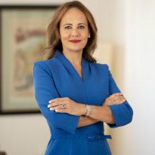 woman with blue blazer with arms crossed