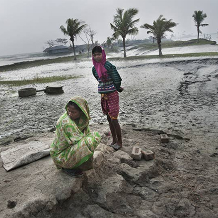 A couple of women in a flood area