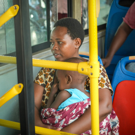 A woman traveling with her child in the bus