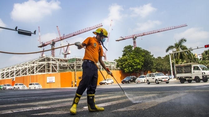 Worker disinfect sprays at the public area of downtown, Kyauktada Township, Myanmar. Photo: Mar Naw
