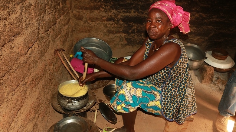 Woman cooking using a biodigester in Burkina Faso