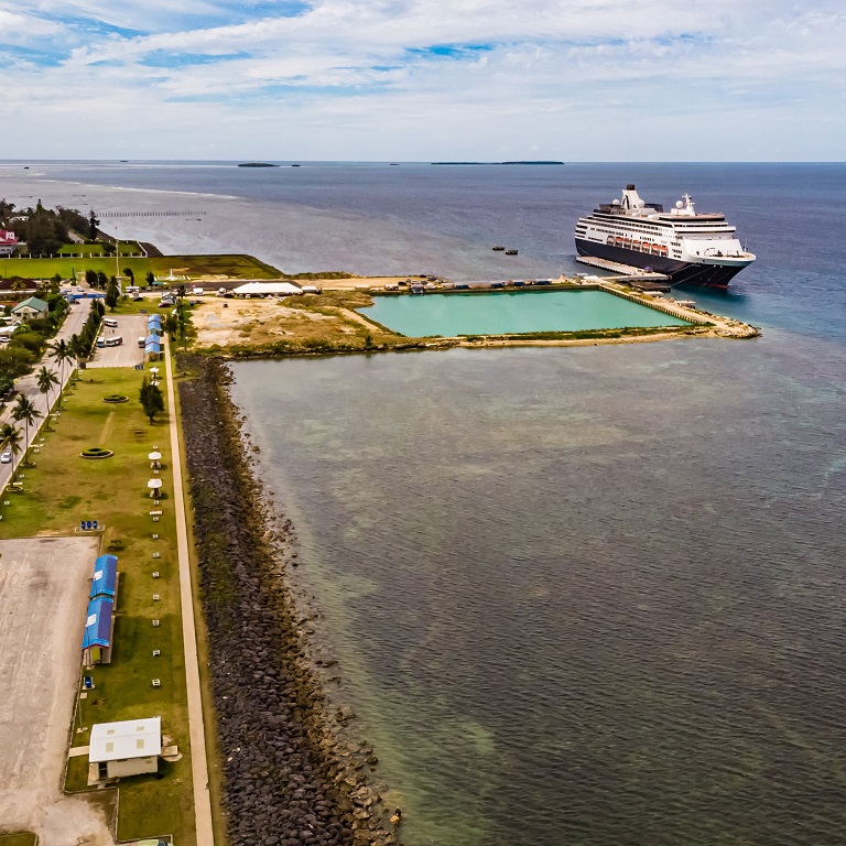 view of a small pool and a pier with a cruise ship at low tide, Tonga