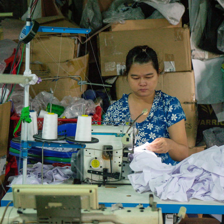 A woman works at a sewing machine in Myanmar
