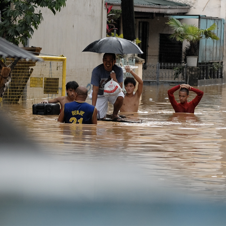 PHILIPPINES SEPT 2009: A group of people swim at Karangalan village circa Sept 2009 in the Philippines. Typhoon Ondoy 