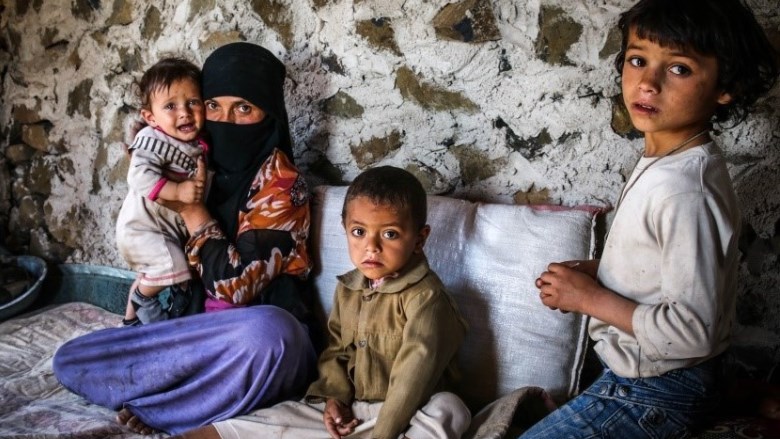 Ashwak Althabibi holding her 8 months son Najranwho was vaccinated as part of the campaign (UNICEF)
