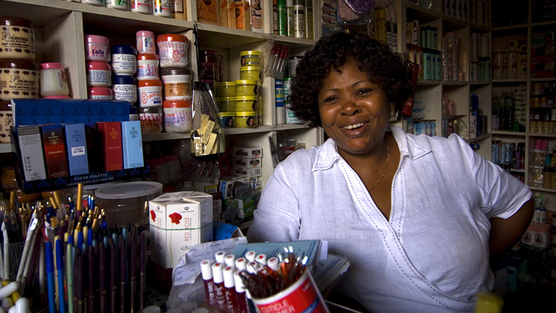 Woman in small shop Ghana. Photo: © Arne Hoel/The World Bank 