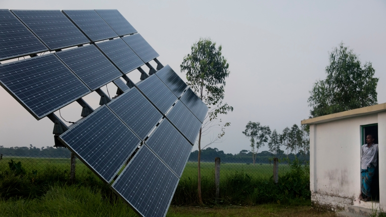 Manik, a solar pump operator for Nusra works near the solar panels in Rohertek, Bangladesh on October 12, 2016. Nusra is an NGO working to bring solar iirrigation to farmers and solar home systems to families in Rohertek. Photo © Dominic Chavez/World Bank