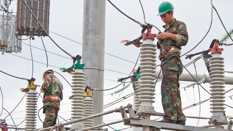 Electricians at a substation