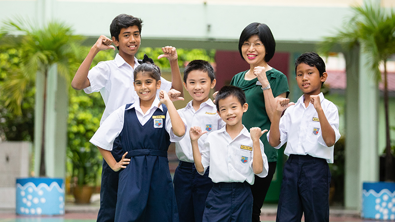 A group of multiracial students smiling with their teacher