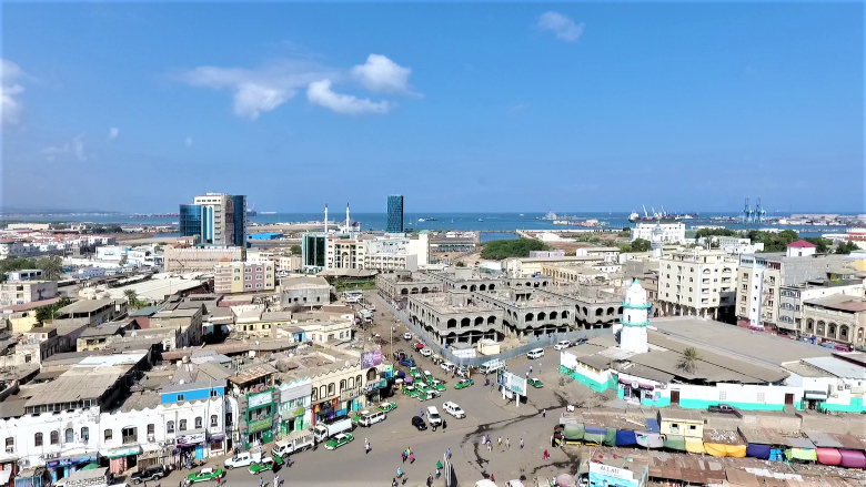 Taxis are lined up in front of shops in a downtown location in Djibouti.