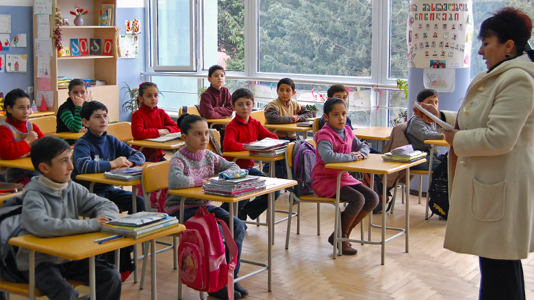 Students listen to their teacher in a renovated classroom