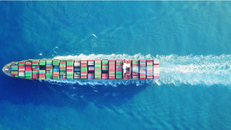 a Large container ship is leaving the port full loaded with containers and cargo - aerial - top down view