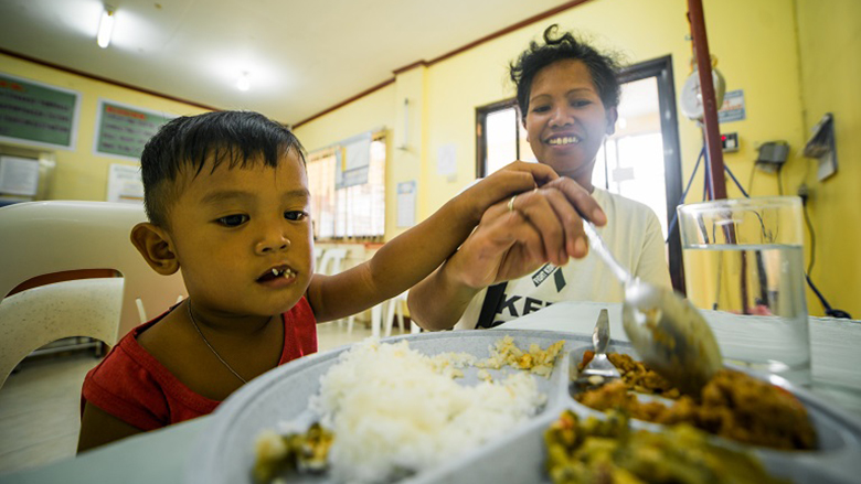 A mother feeding her child in Pampanga, Philippines
