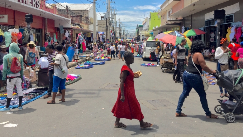 People in Kingston walking down the street and shopping during trade days