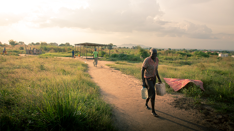 A man carries containers in South Sudan