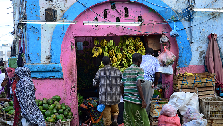 People browse fruit for sale at a food stall in Djibouti