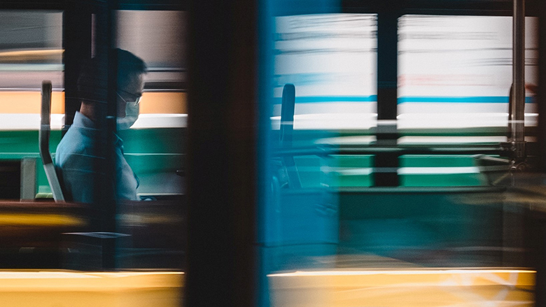 A man wearing a mask on a bus. Photo: © Chapman Chow/Unsplash