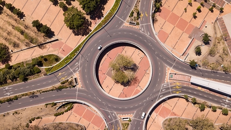Aerial view over a traffic intersection during COVID-19 lock down, with empty streets. Photo: © fivepointsix/Shutterstock