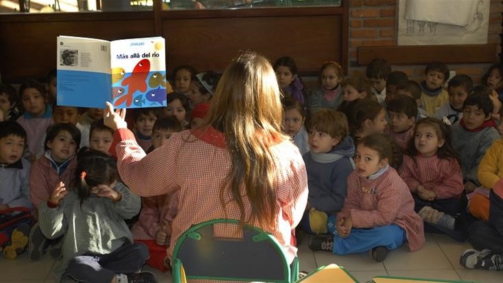 A teacher reads to her students in a classroom in Uruguay.