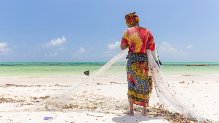 A woman fishing on Paje beach, Zanzibar, Tanzania. Photo: © Matej Kastelic/Shutterstock