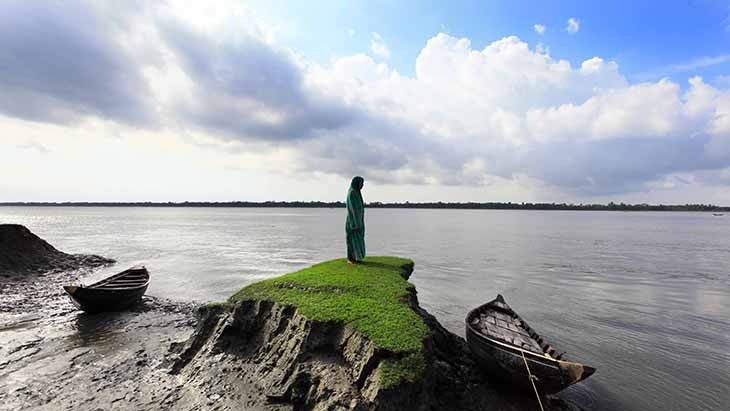 Woman standing in Bangladesh coast. 