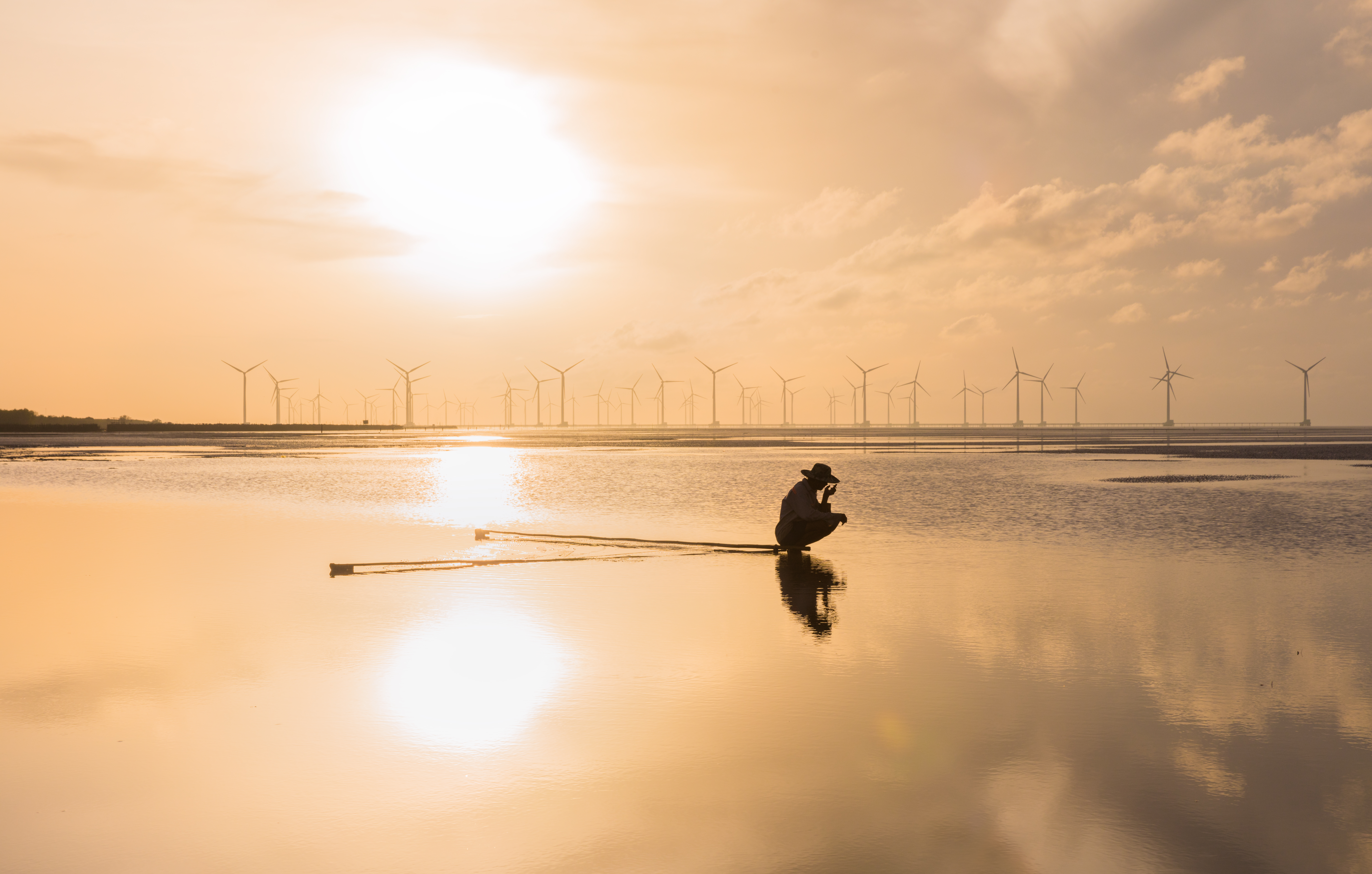 fisherman in the sea off the coast, Nha Mat, Vietnam 