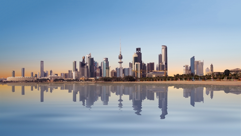 A peaceful view of Kuwait cityscape during sunrise.