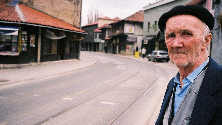 An elderly man waits for the tram. Bosnia and Herzegovina.