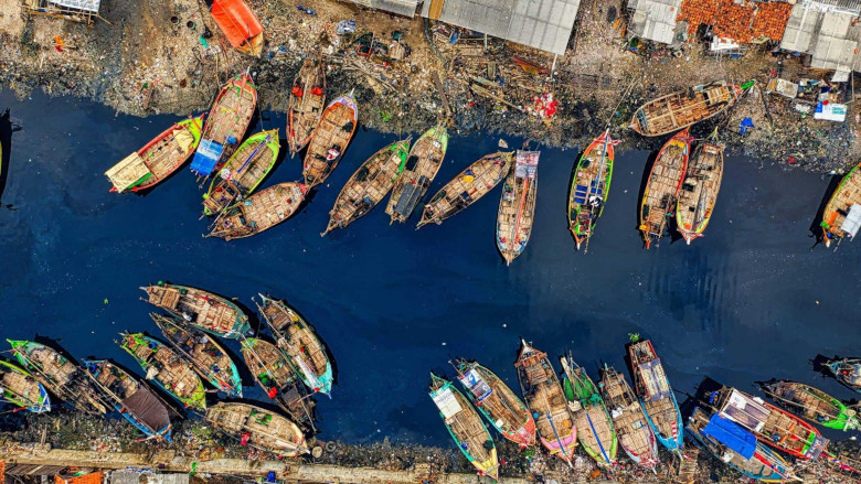 Aerial view of fishing boats docked along a river in Indonesia. Tom Fisk/Pexels.com