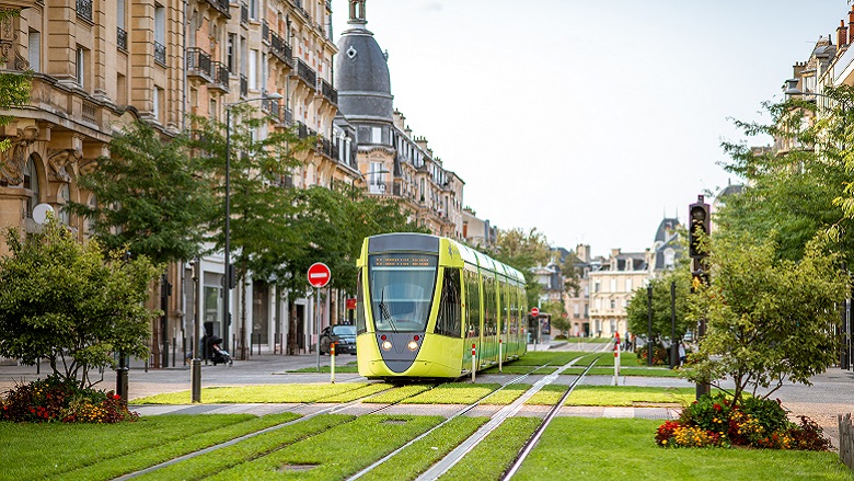 Street view with green railway of public transport in Reims, France.