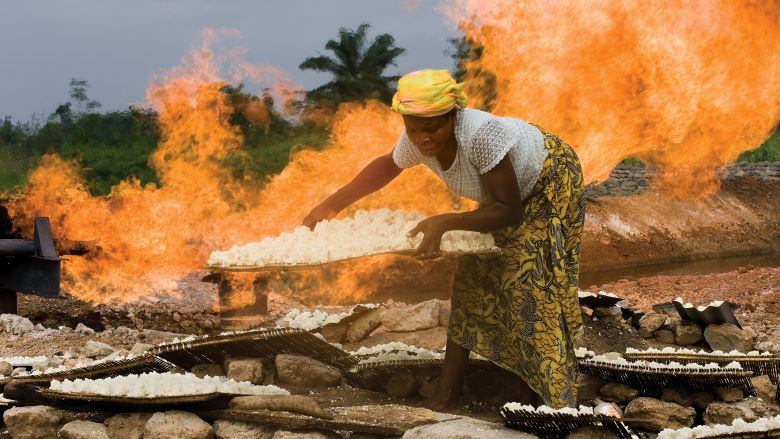 Woman cooks near gas flare Niger Delta