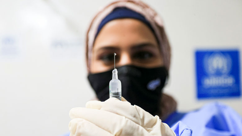 A health worker prepares a dose of Covid-19 vaccine, at a medical center in Zaatari refugee camp, in Mafraq, Jordan.