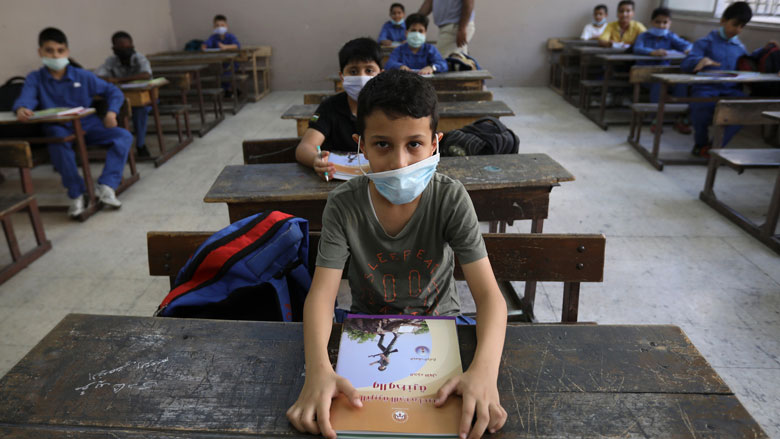 Students wearing protective face masks attend a class at one of the public schools on the first day of the new school year, amid fears of rising number of the coronavirus disease (COVID-19) cases in Amman, Jordan.