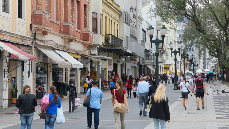People walking in a busy shopping street in Curitiba, Brazil.