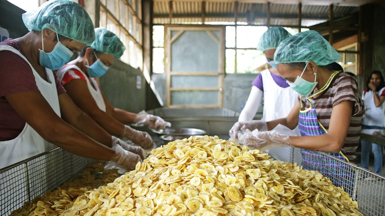 Workers at a banana chips processing facility in the Philippines