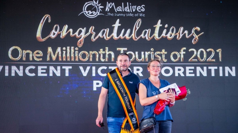 Man and woman receiving congratulations for being the 1 millionth tourist of 2021 for Maldives