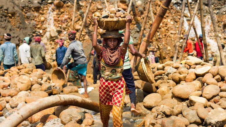 Female laborer carrying stones after extraction