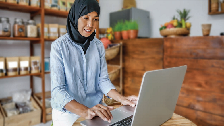 Indonesian woman typing at her laptop